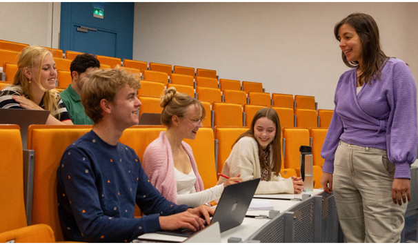 Engaging lecture with students and a lecturer in a small, interactive learning environment.